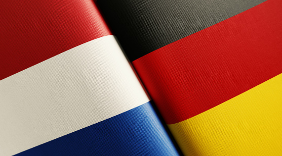 Dutch and German flag pair. Horizontal composition with copy space and selective focus.