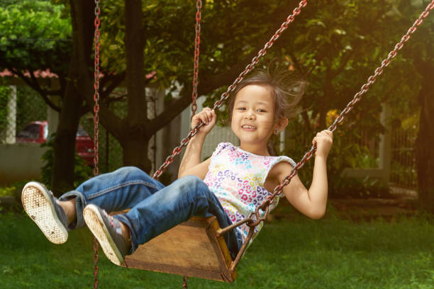 istock Asian girl smiling on a swing 1159236614