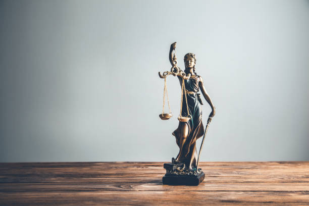 istock justice lady  on the wooden table 1159236666