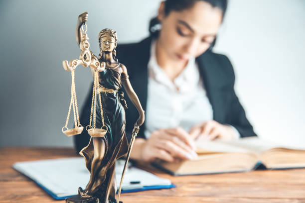 istock woman hand book with  justice lady on desk 1159236671