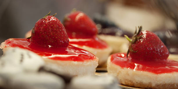 istock cakes with strawberry in a cafe or in a shop window 1159236781