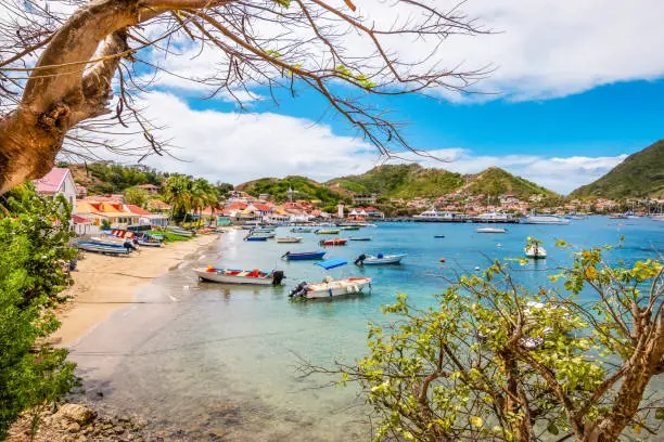 Landscape with small beach and bay with boats. Terre-de-Haut, Les Saintes, Iles des Saintes, Guadeloupe, French Caribbean Islands. Bright and colorful image.