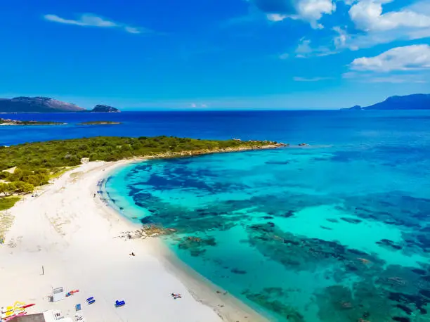 Aerial view of Bados, nice sandy beach with the mountains and the islands in background, North Sardinia,Olbia