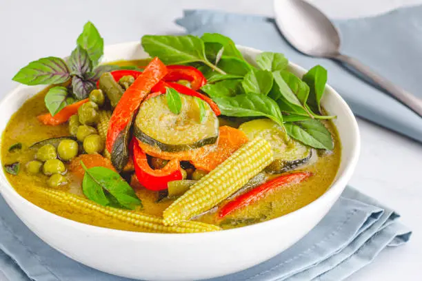 Vegan Thai Green Curry on White Background Close-Up Photo. Healthy Food Photography.