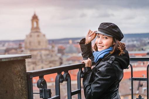 Happy woman travel in Europe, standing on the overlooking site against beautiful Dresden cityscape view