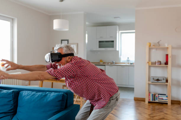 istock Senior old man elderly enjoy playing game with VR Virtual Reality 1159240355