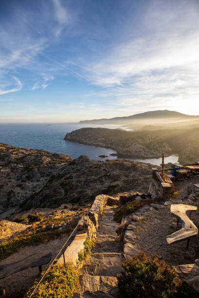 Sunset over sea cliffs and low clouds with clear sky view from Cap de Creus, Catalonia (SPAIN)