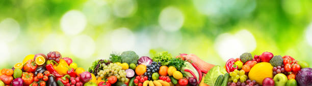 istock Panorama fresh fruits and vegetables on green background. 1159244067