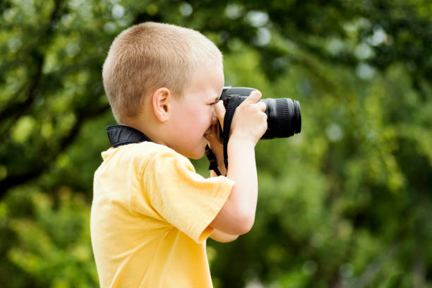 istock little boy photographer 1159247356