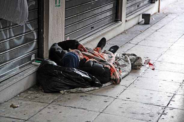 Sleeping homeless Man sleeping on the sidewalk. homeless person stock pictures, royalty-free photos & images