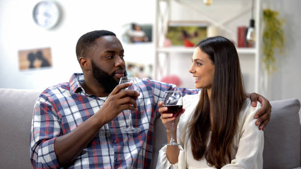 istock Young couple having romantic date with wine beverage at home, togetherness 1159251328
