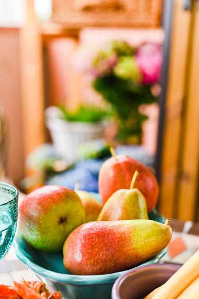 istock Beautiful and ripe pears on the dinner table. Summer fruits for breakfast. 1159252217