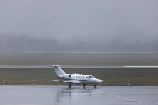istock a private jet on an rainy airport 1159252646