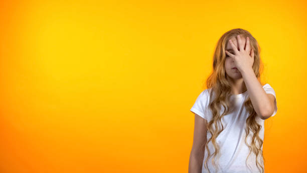 istock Funny schoolgirl unhappy with assignment making facepalm gesture, tired kid 1159252708