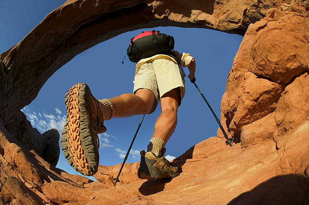 Bottom of Boot and Hiker Under Rock Arch stock photo