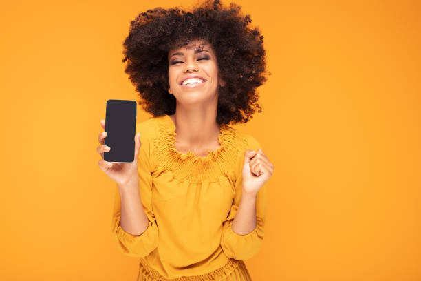 istock Excited afro girl with mobile phone. 1159261513