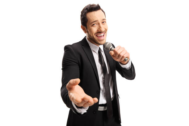 istock Handsome male singer in a black suit singing on a microphone 1159267644