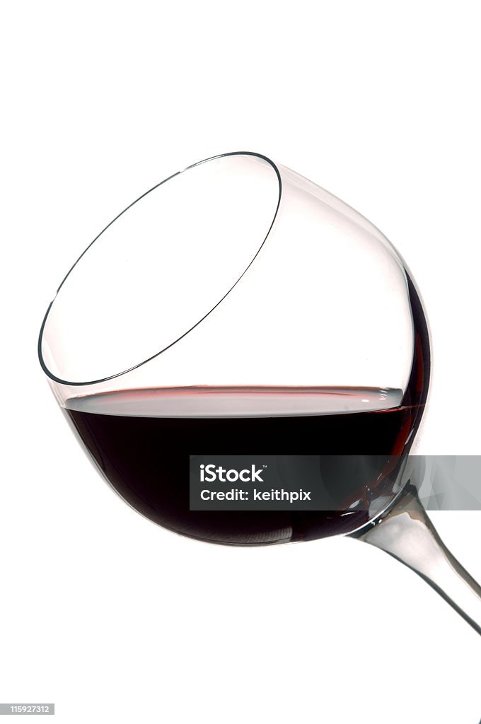 Merlot a glass of red wine tilted for its bouquet isolated on white Alcohol - Drink Stock Photo