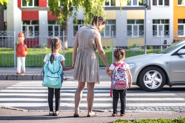 istock Back to school education concept with girl kids, elementary students, carrying backpacks going to class 1159273194