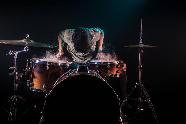 istock musician playing drums with splashes, black background with beautiful soft light 1159273368