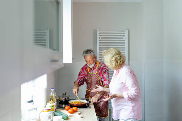 istock Senior couple preparing lunch 1159274514