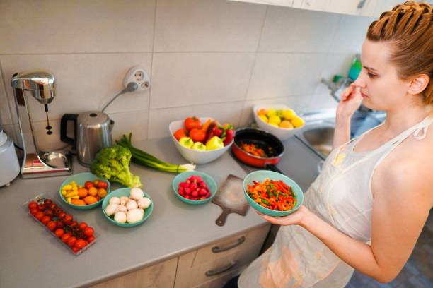 istock Woman make vegan dinner 1159274610