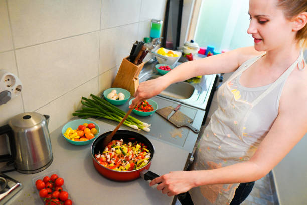 istock Woman make vegan dinner 1159274614