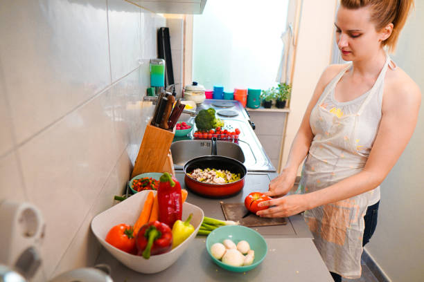 istock Woman make vegan dinner 1159274627