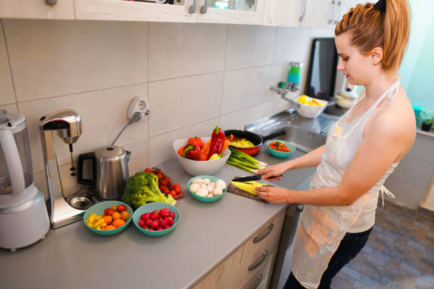 istock Woman make vegan dinner 1159274631