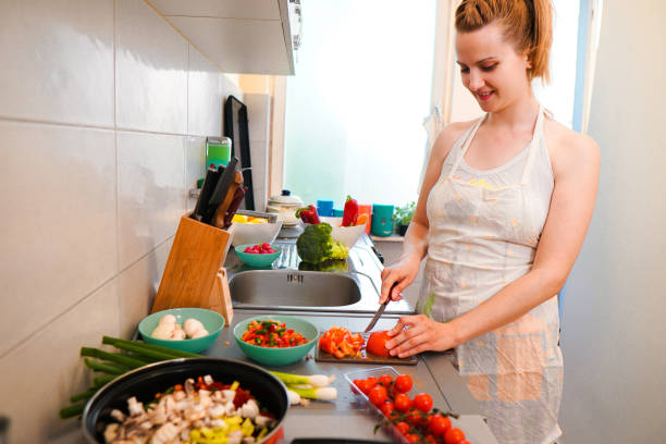 istock Woman make vegan dinner 1159274660