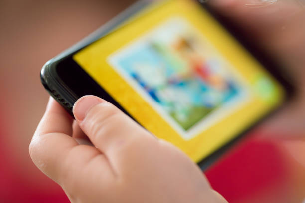 istock Multi-racial girl getting screen time watching content on a cell phone 1159275174