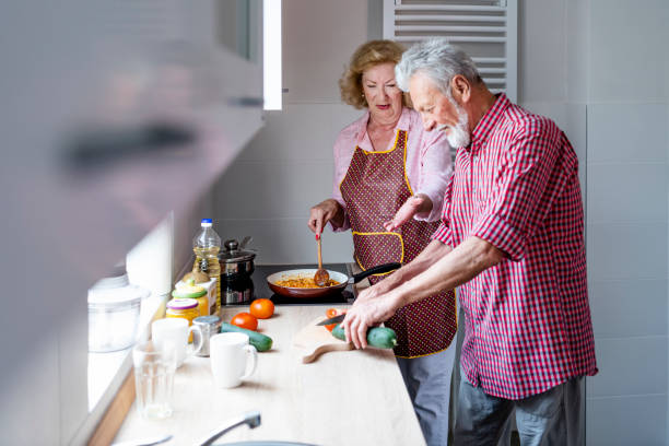 istock Senior couple preparing lunch 1159275201