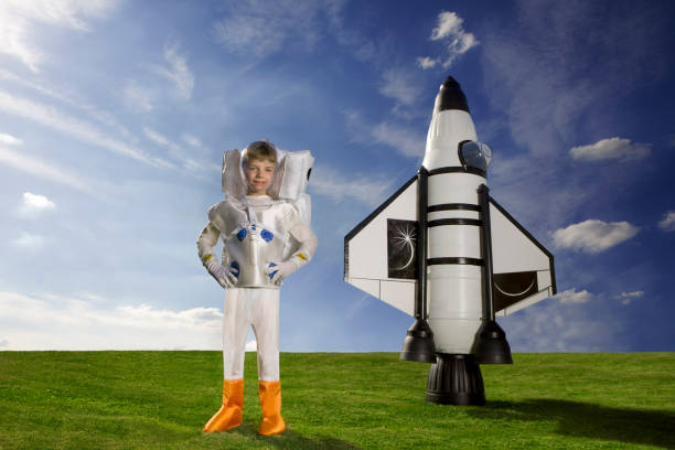 istock Young boy dressed as an astronaut standing in front of his rocket 1159275209