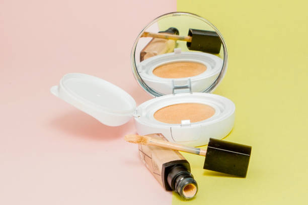 istock Make up products spilling on to a bright yellow and pink background with copy space 1159276173