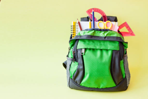 istock Composition with backpack and school stationery on yellow background 1159276247