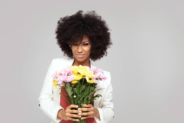 istock Young elegant afro girl with flowers. 1159277377