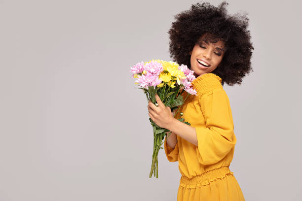istock Young beautiful afro girl with flowers. 1159277521