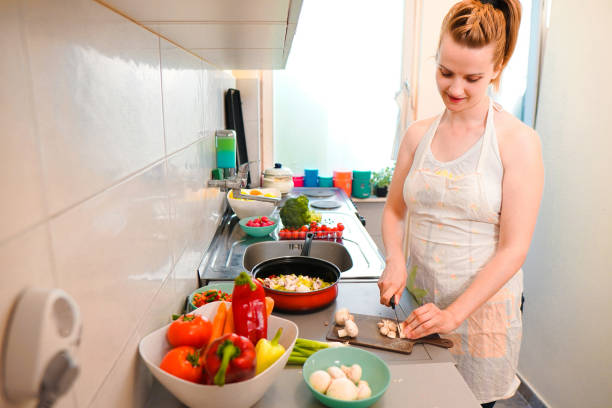 istock Woman make vegan dinner 1159278275