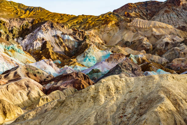 Death Valley, California, USA - December 17, 2018:  Sunrise at the Artists Palette rock formation.  Vivid colors and bold mineral formations create this natural attraction.