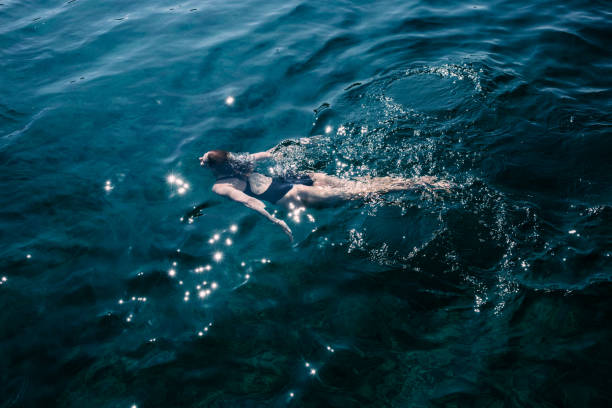 Young woman swimming in the sea stock photo