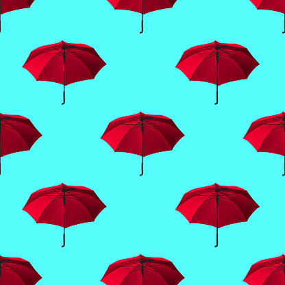 Bright red umbrellas on a light blue background