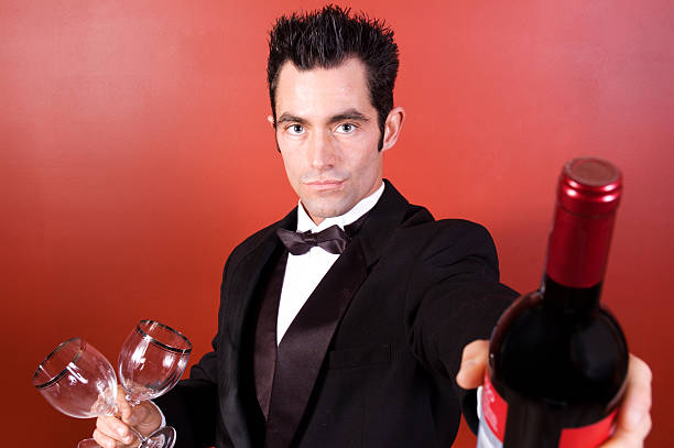 istock Man in Tuxedo with a bottle of wine 115928189