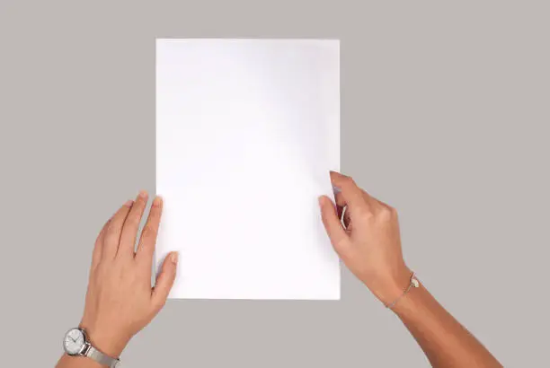 Photo of Person holding white empty paper