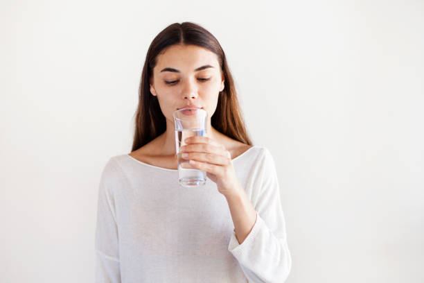 istock Young woman drinking water 1159288856
