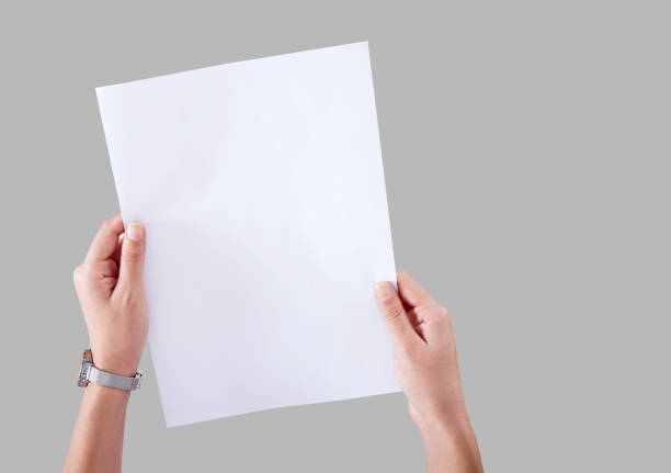 istock Person holding white empty paper 1159288956