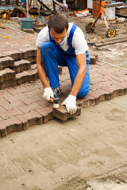 laying paving slabs on city square, repairing sidewalk the master paves the paving slab professionally pavement ends sign stock pictures, royalty-free photos & images