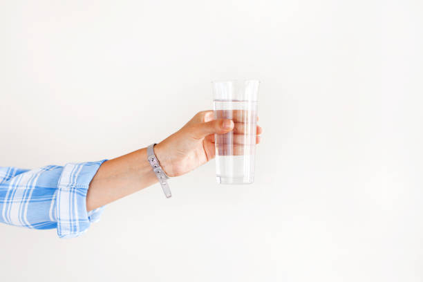 istock Woman hand holding drinking water 1159289025