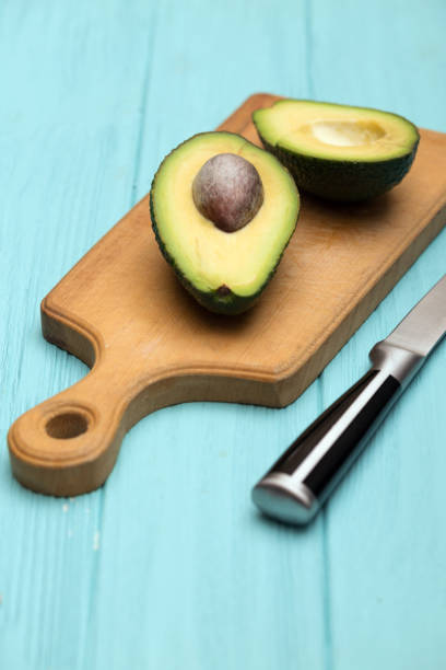 istock avocado on cutting board on blue background