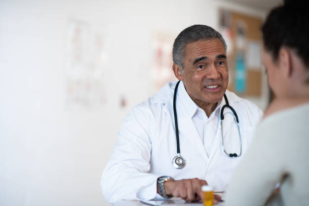 istock Male doctor talking to his patient 1159291748
