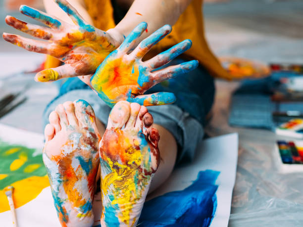 istock modern art festival feet hands multicolor paint 1159292224